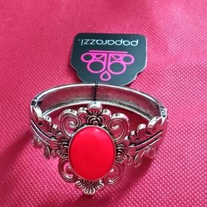 Spring clip ornate braclet with pink center piece.